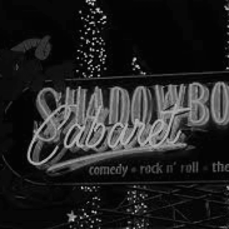 A vintage black and white photo of a sign that says Shadowbox Cabaret, capturing the essence of history.