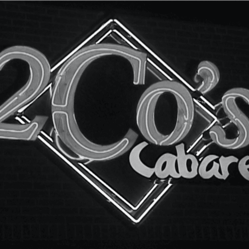 A historic black and white photograph of a neon sign that says 2 o's cabaret.